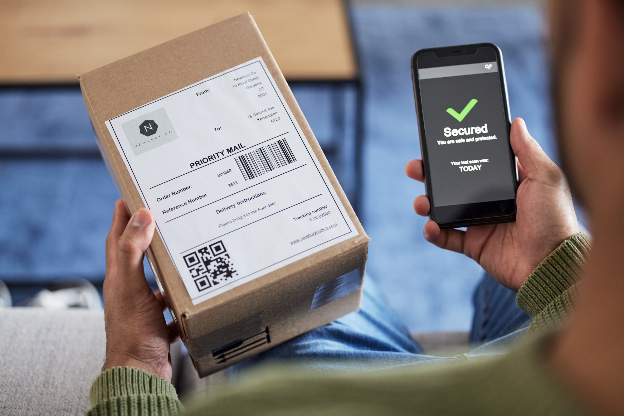 Box label, phone screen and person hands reading security verification check, safety scan or track