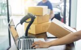 Courier hands Business woman work at home office checking parcel package box by keying machine track