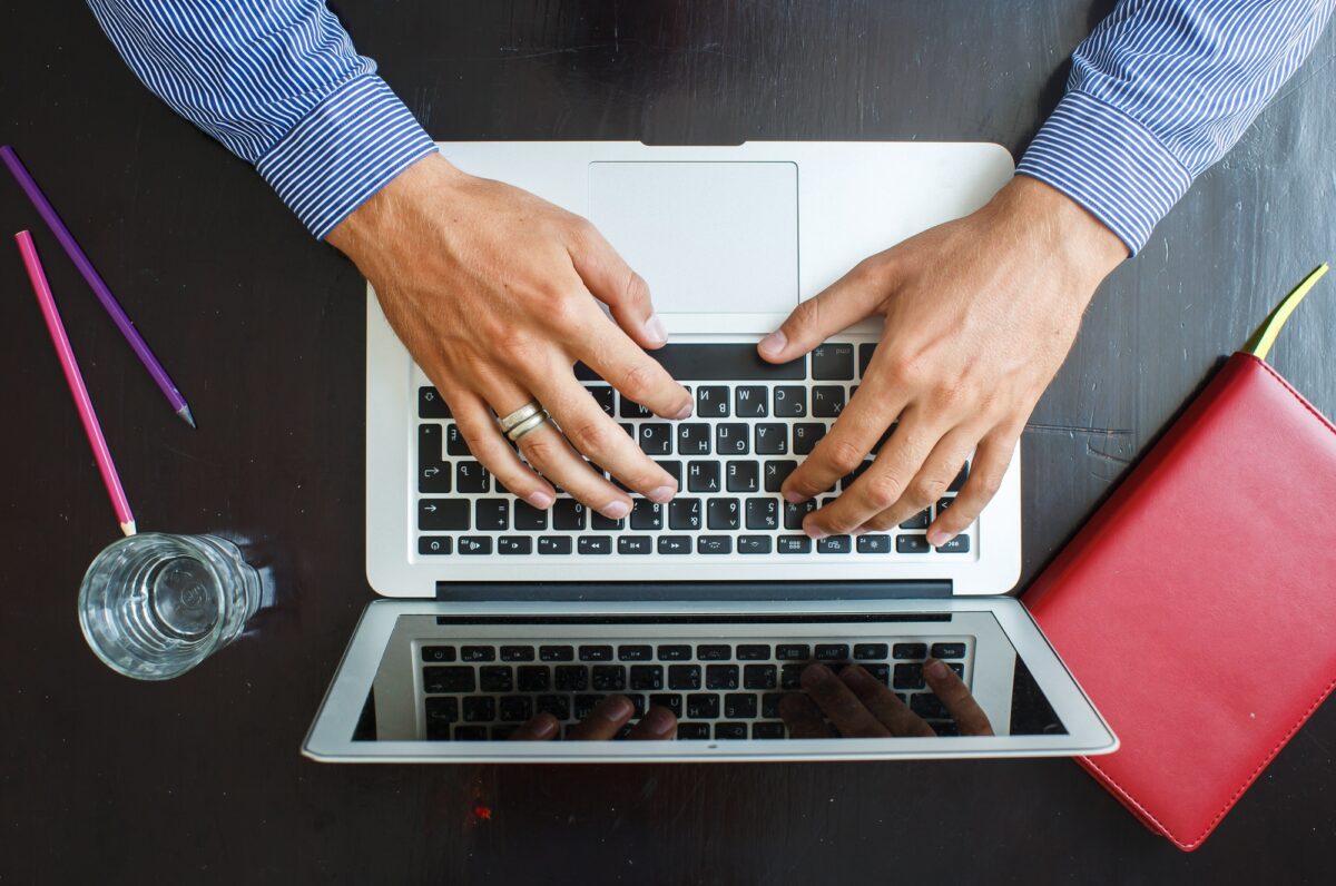 Cropped image of a young man working on his laptop at home