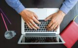 Cropped image of a young man working on his laptop at home