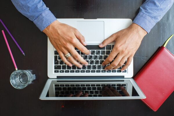 Cropped image of a young man working on his laptop at home
