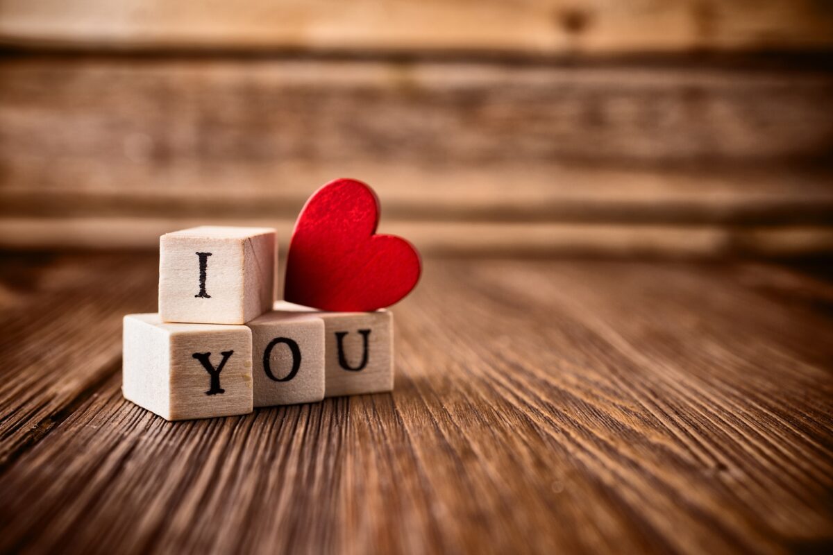 Love message written in wooden blocks. Red heart.