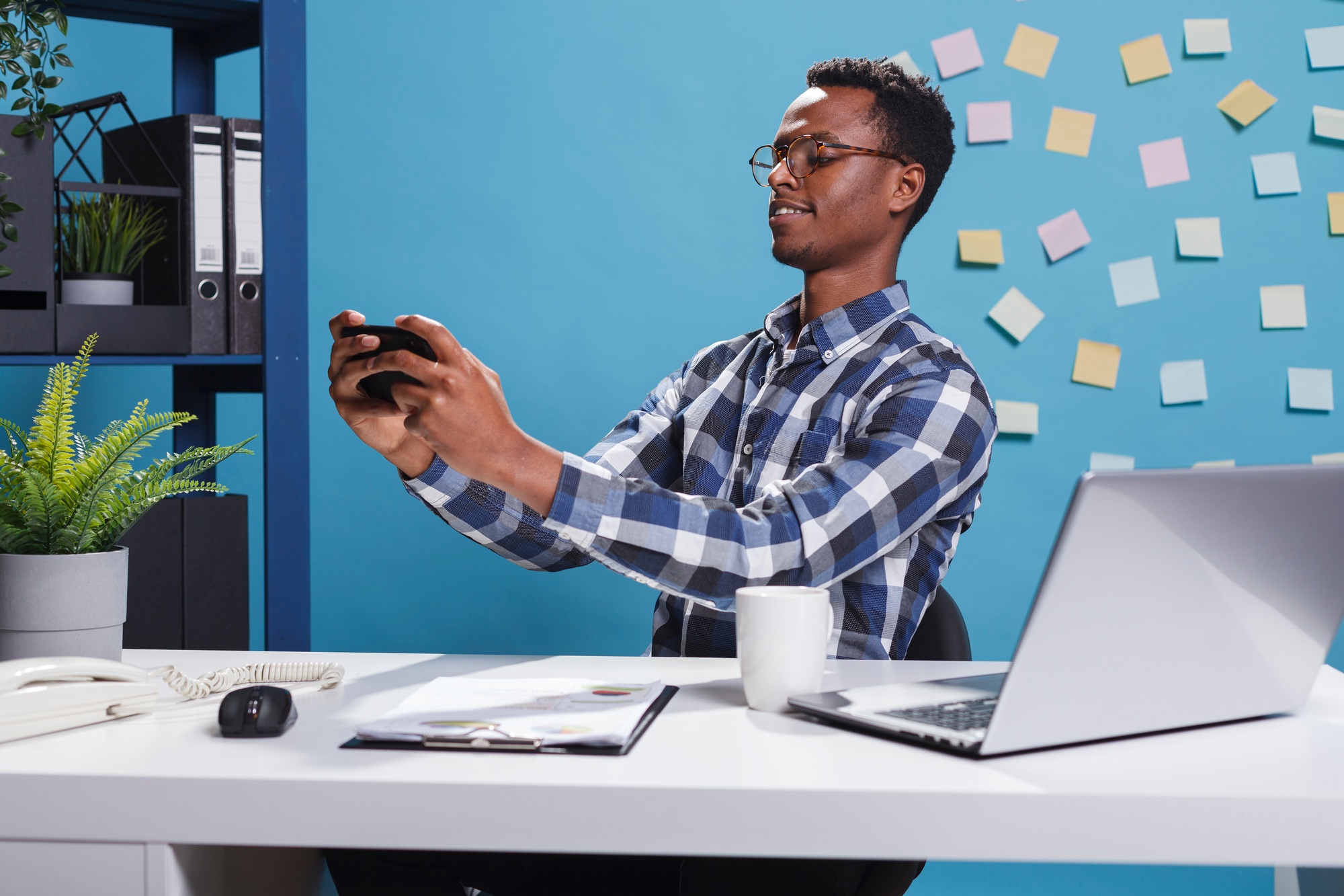 Marketing company financial advisor winning game on mobile device while at work