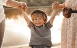 Parents holding hands of smiling child