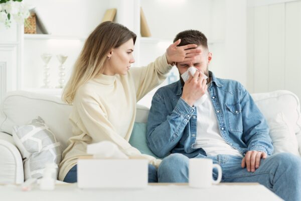 Take care. Woman touching forehead of ill husband