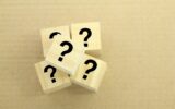 wooden cube with question mark.