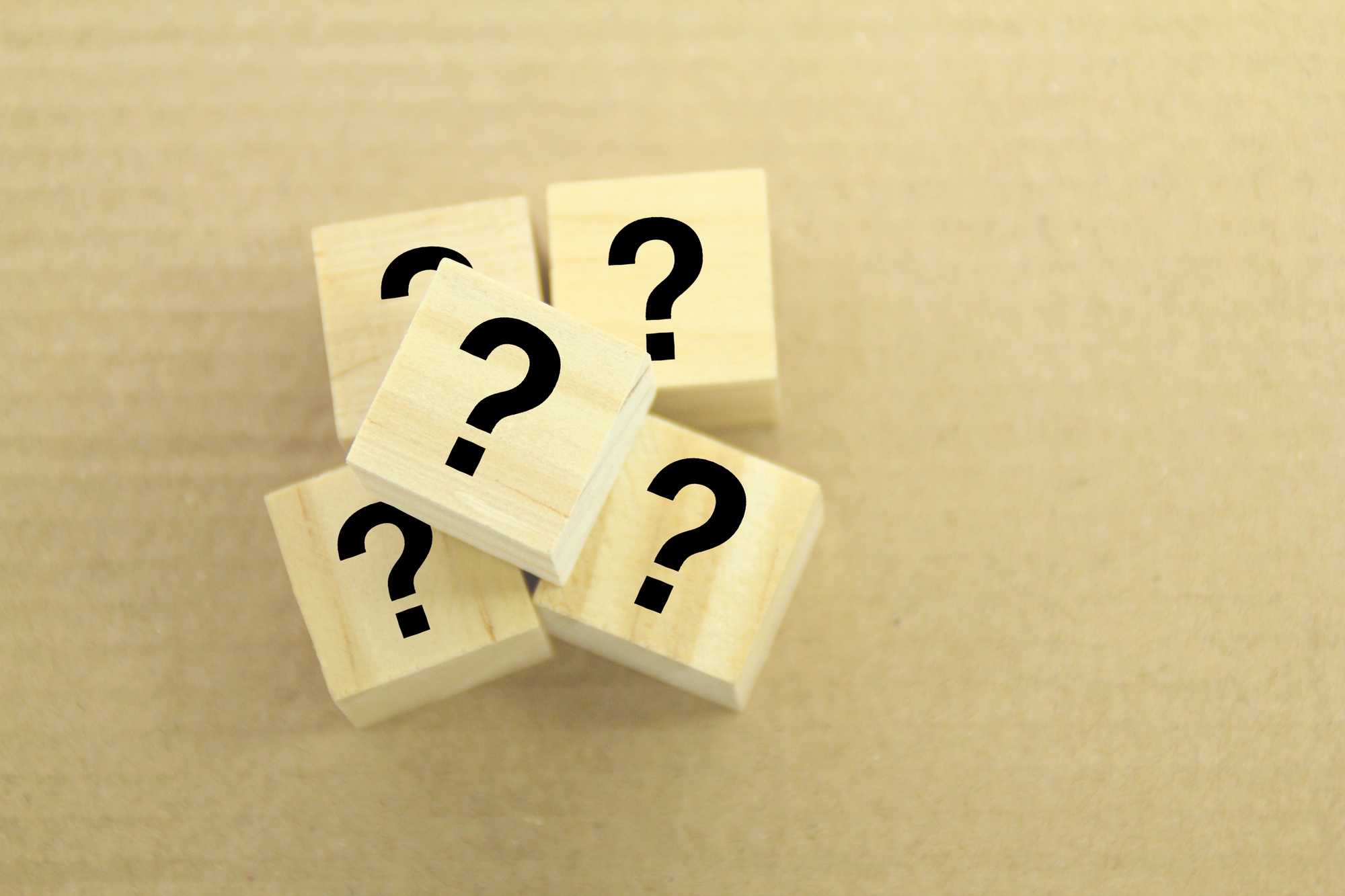 wooden cube with question mark.